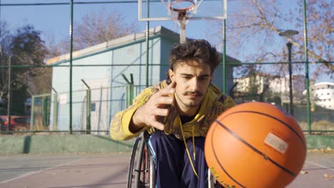 Ambitious-disabled-basketball-player-in-wheelchair-outdoors.